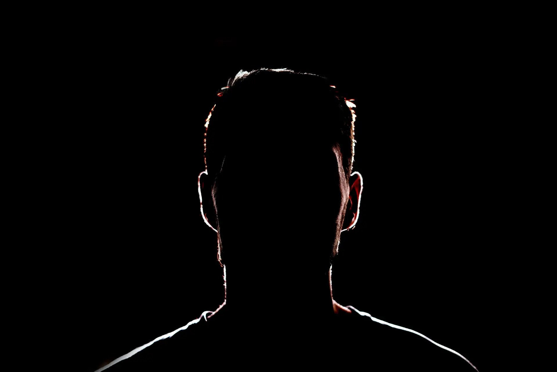 a dark backlight shadow silhouette of male person, incognito unknown profile
